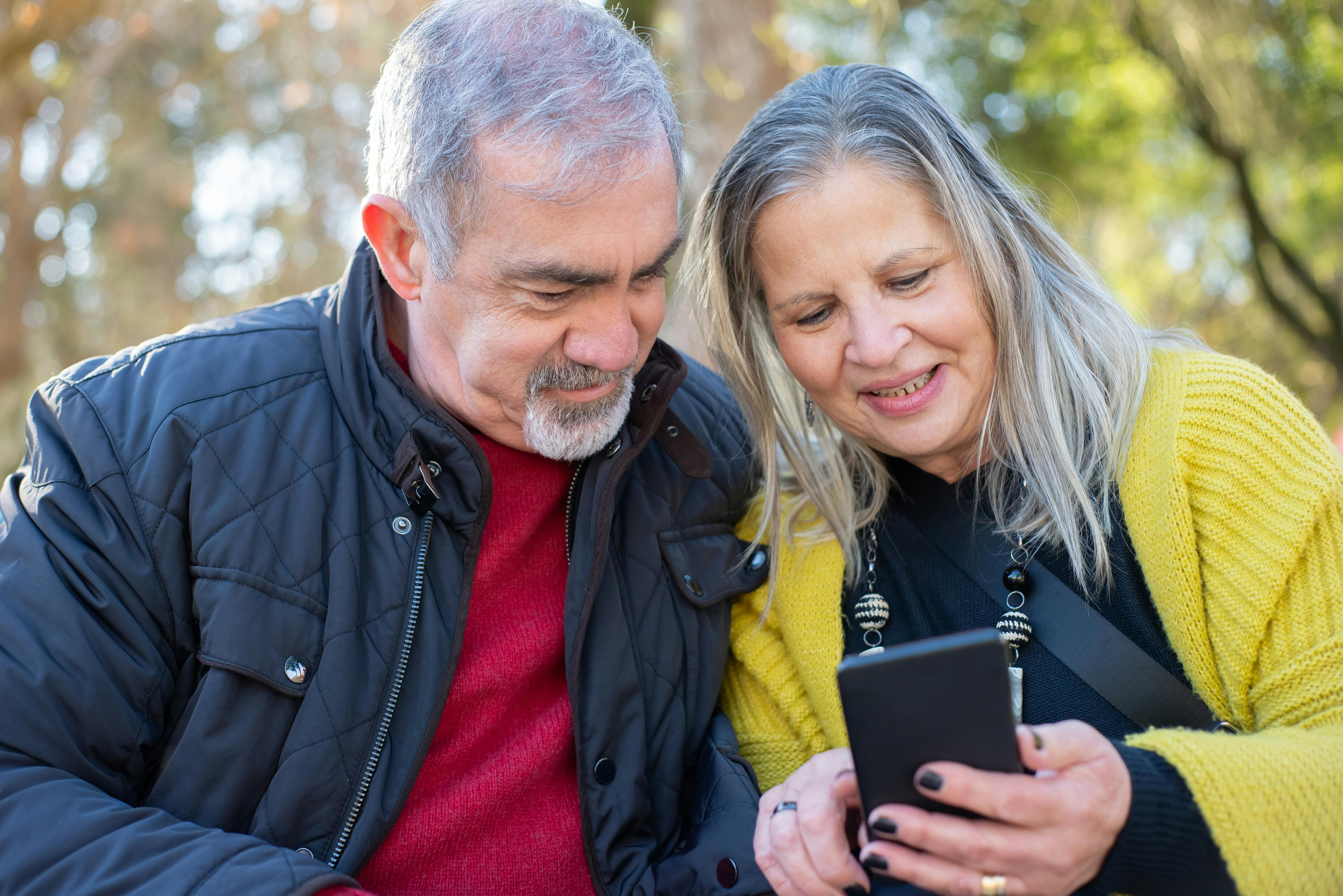 Happy couple reviewing Medicare options with an agent
